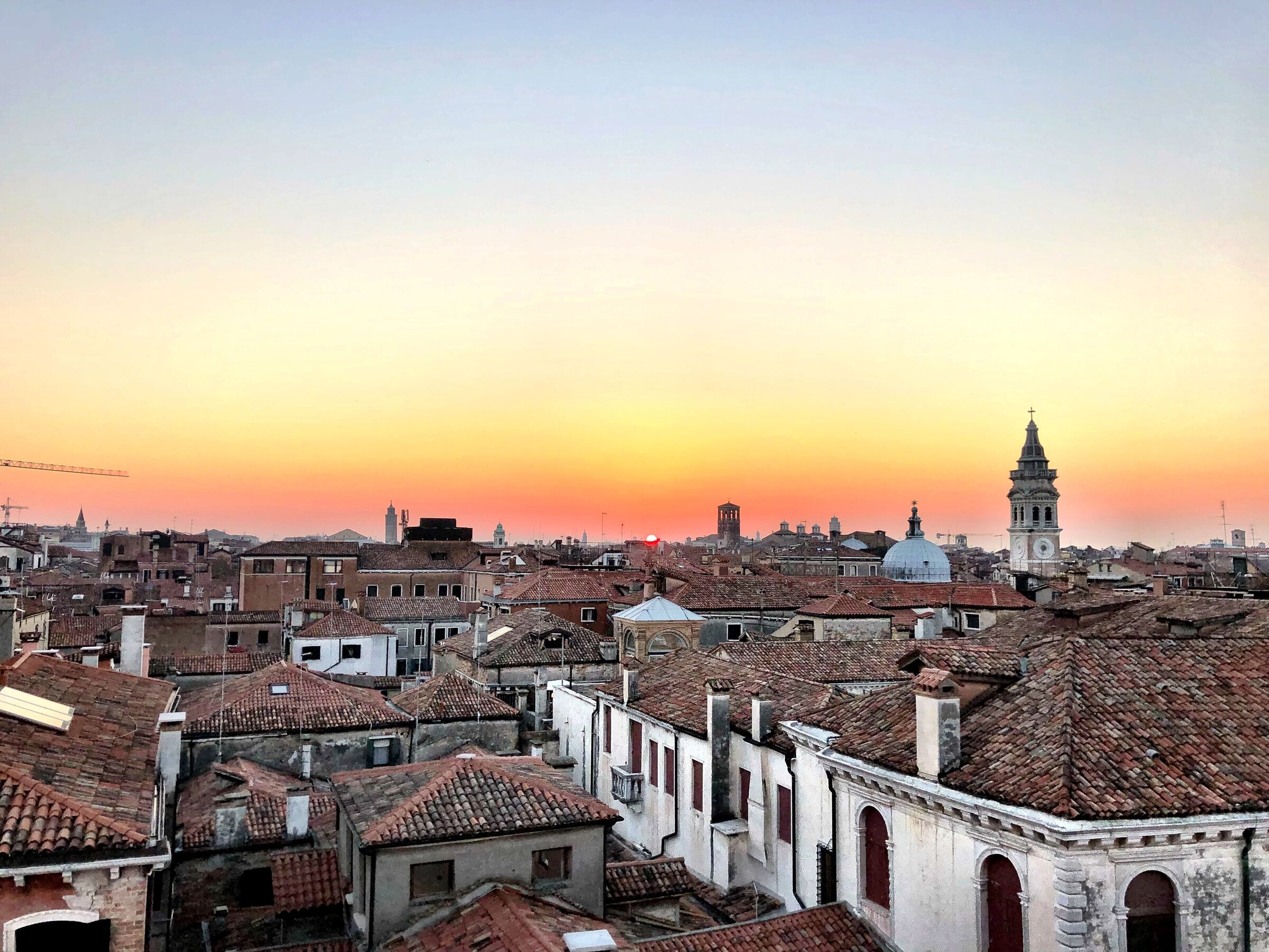 Sunset over European city rooftops